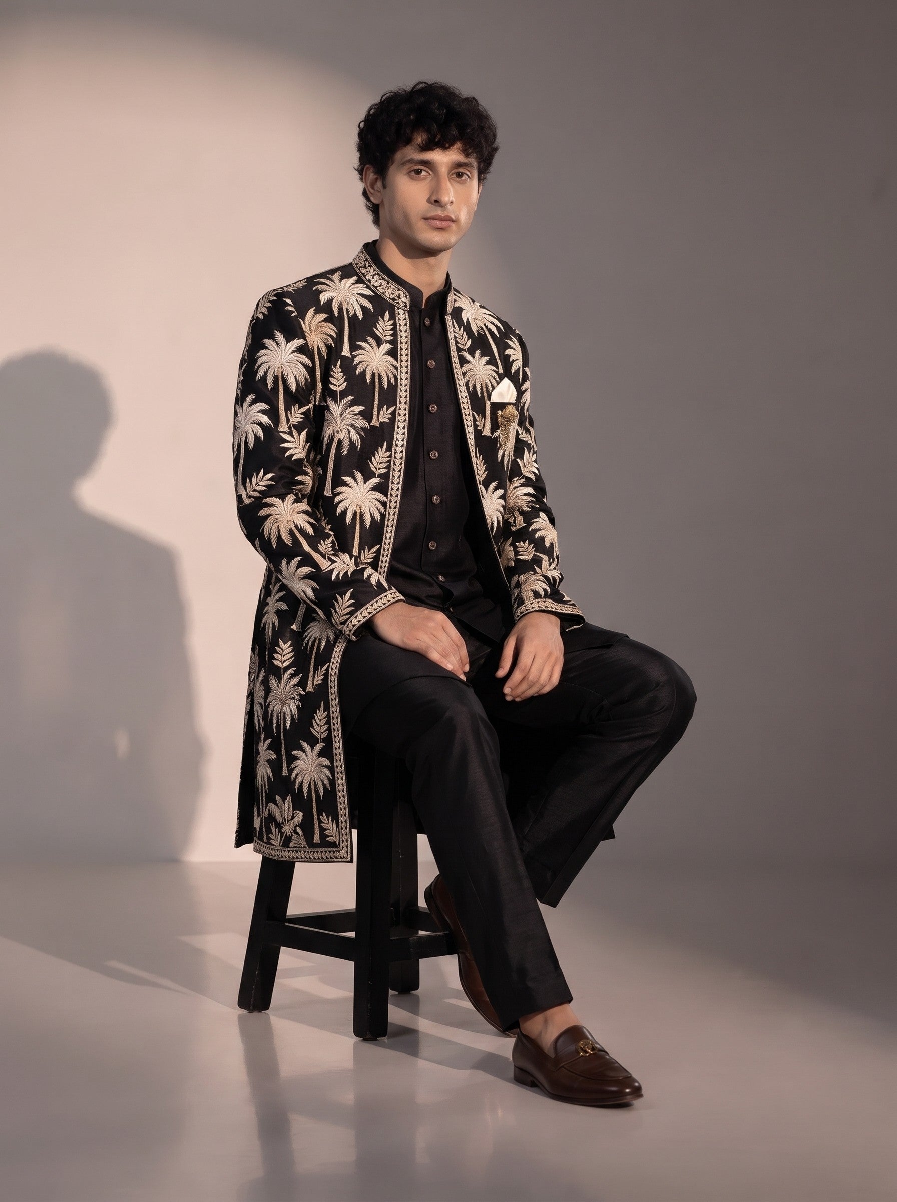 Black palm embroidered silk indowestern for men - seated pose