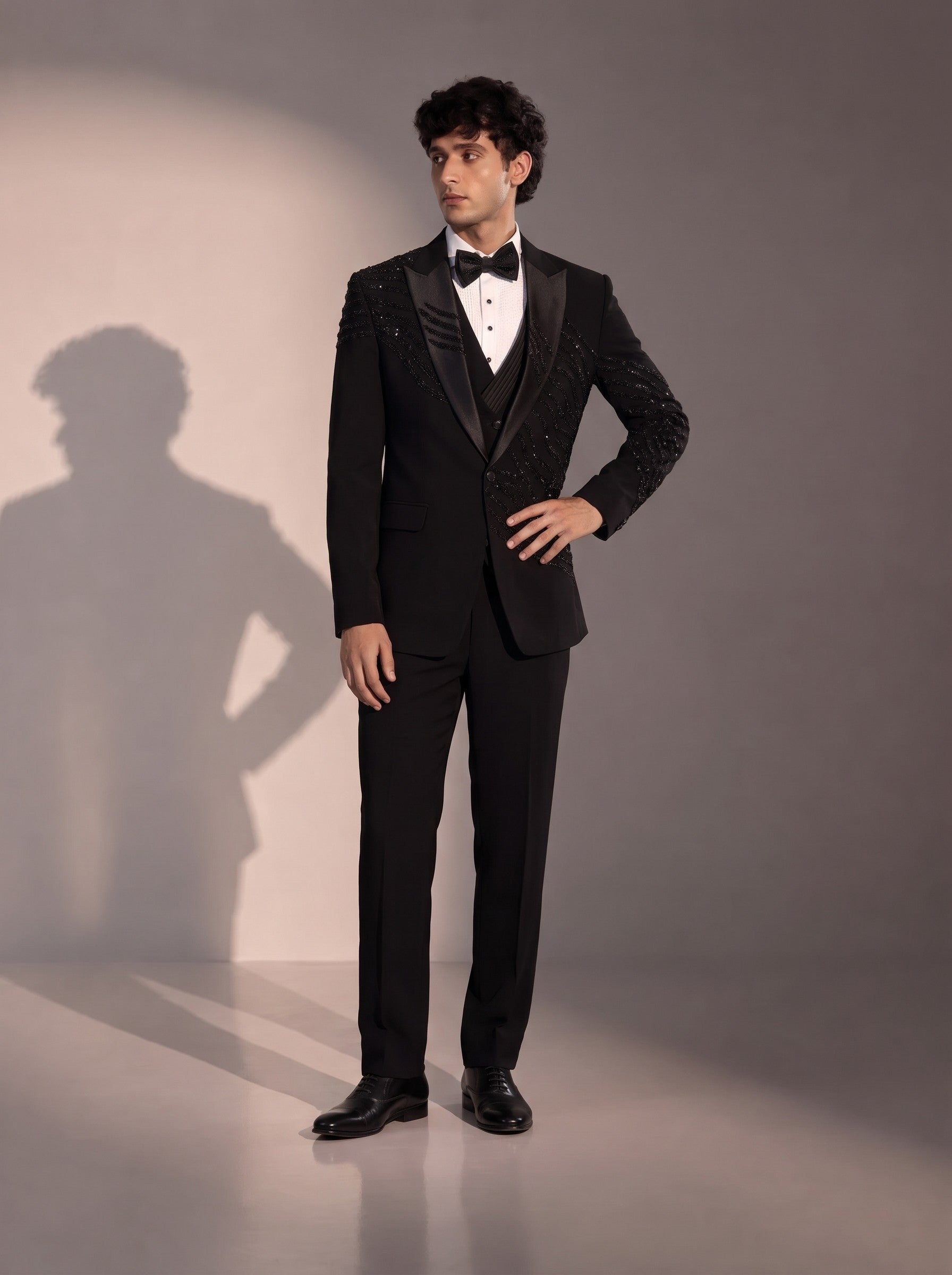 Black peak lapel beaded tuxedo suit for men - front view