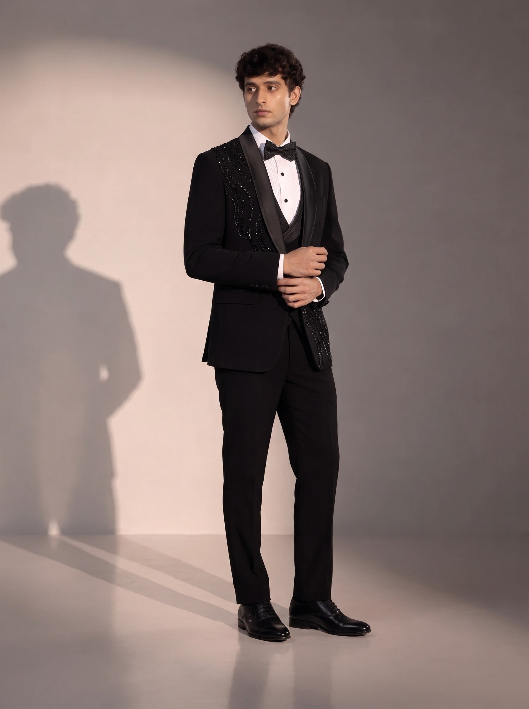 Black peak lapel beaded tuxedo suit for men - three-quarter view