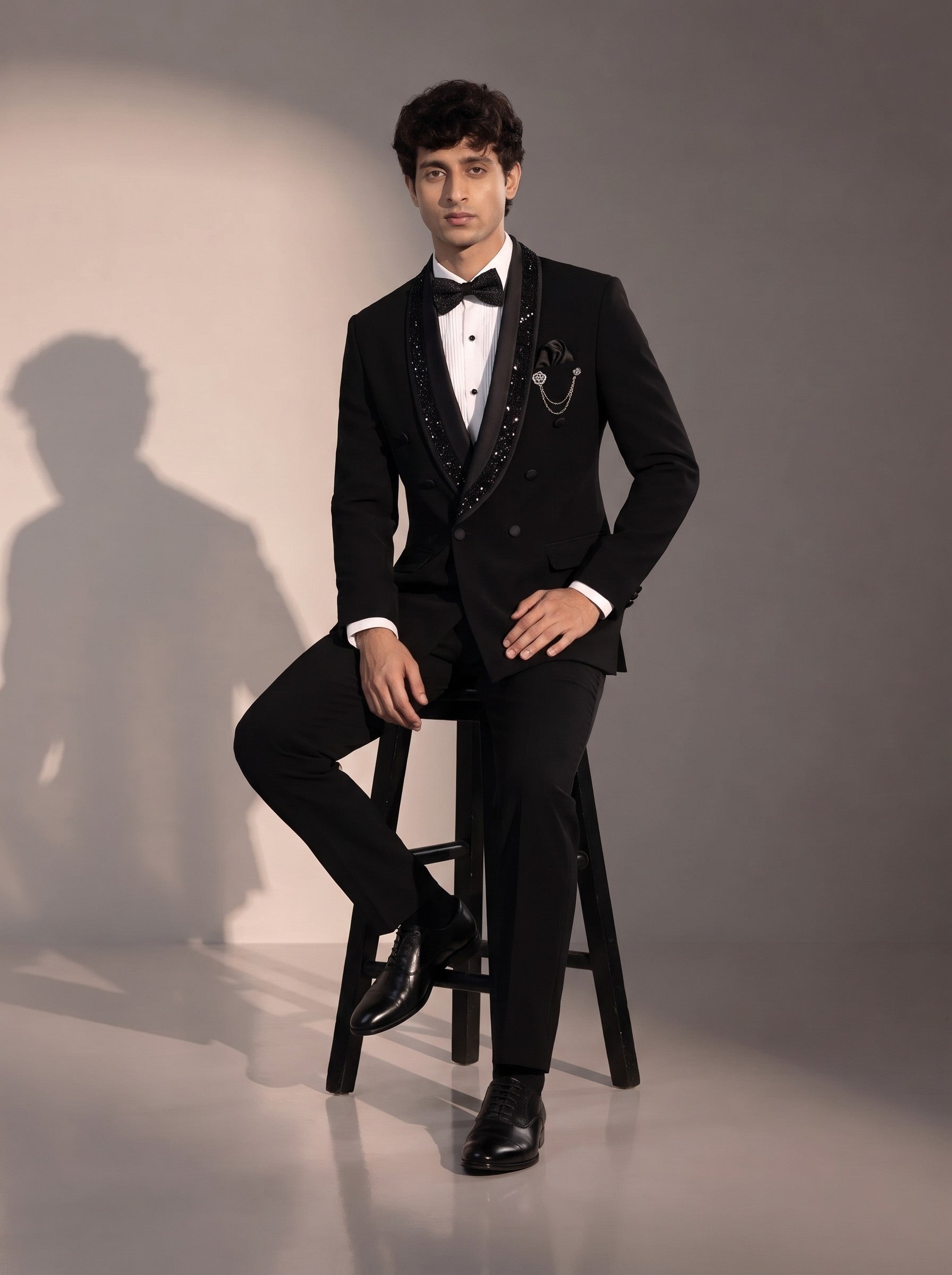 Black sequin double breasted tuxedo suit for men - seated pose