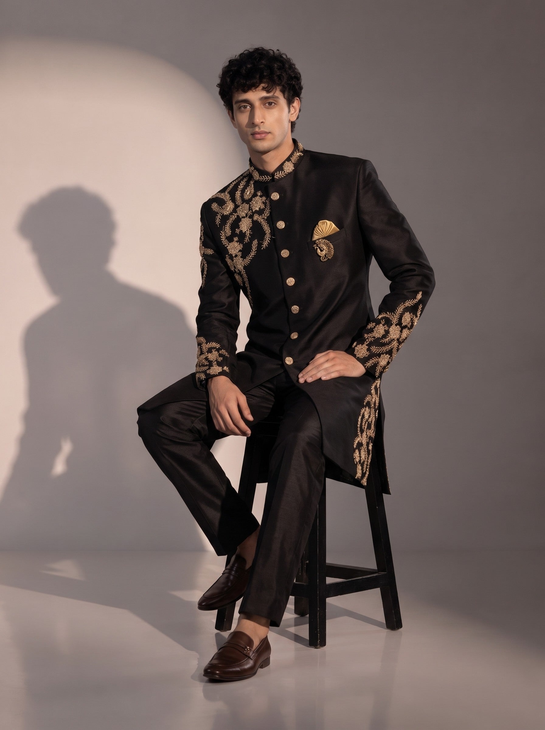 Black silk embroidered indowestern for men - seated pose