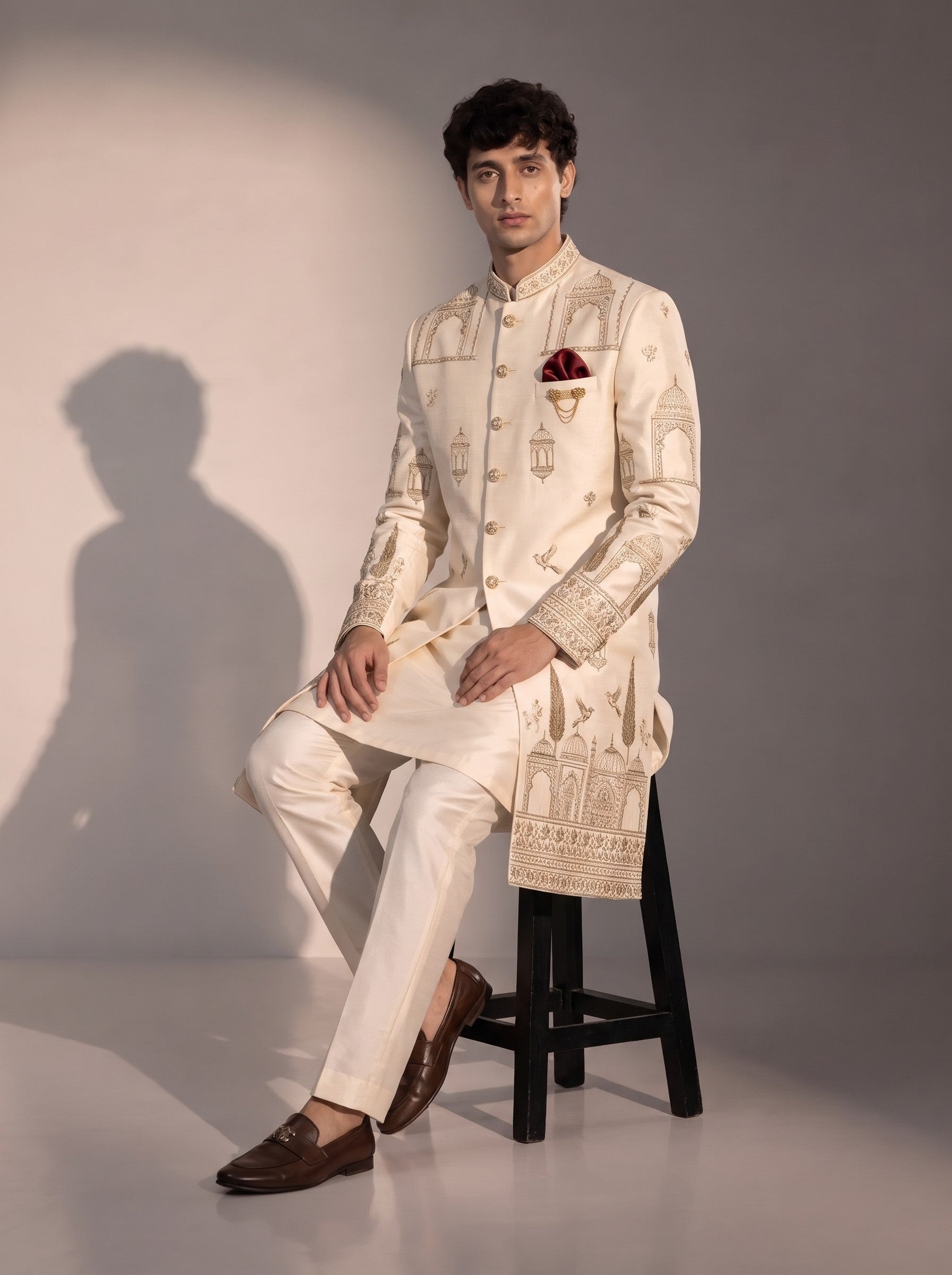 Cream Mughal embroidered silk indowestern for men - seated pose