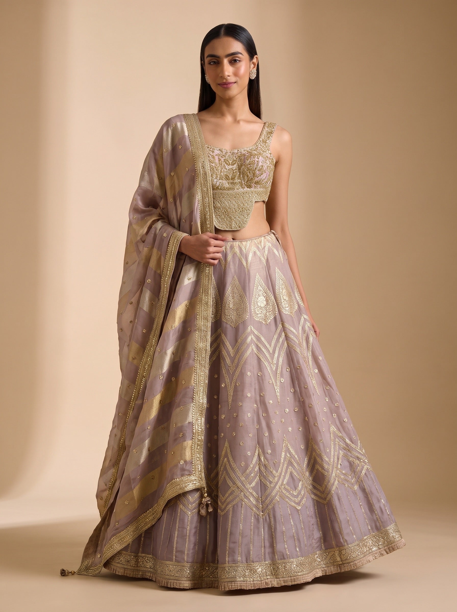 Mauve silk lehenga set worn in a relaxed front pose, with embroidered blouse and matching dupatta