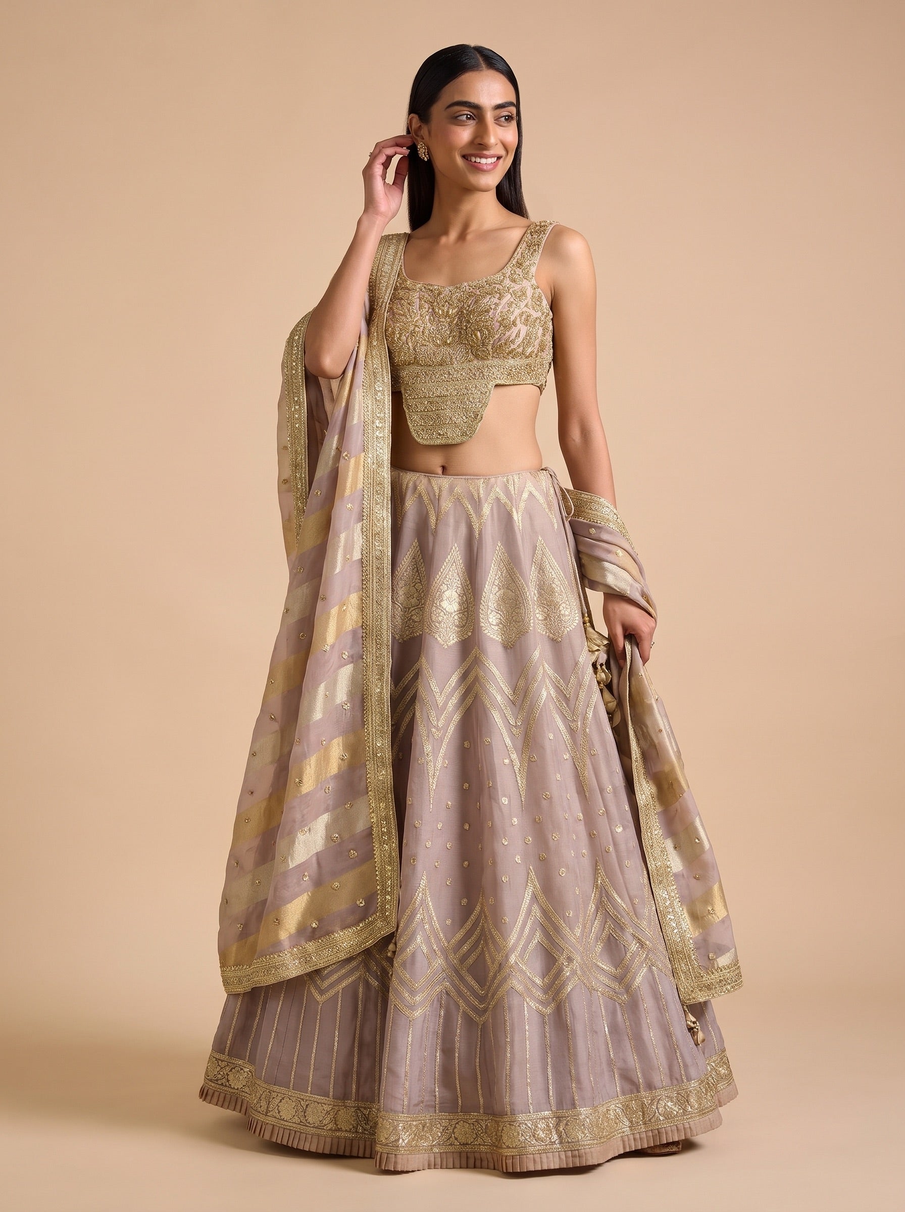 Mauve silk lehenga with embellished blouse and dupatta, casual standing pose