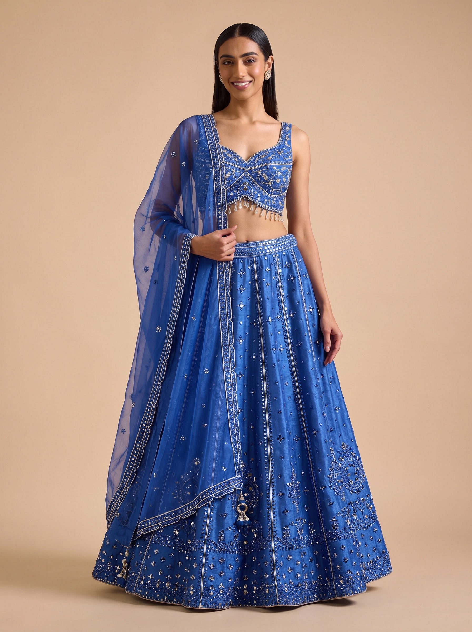 Royal Blue silk lehenga set worn in a relaxed front pose, with embroidered blouse and matching dupatta