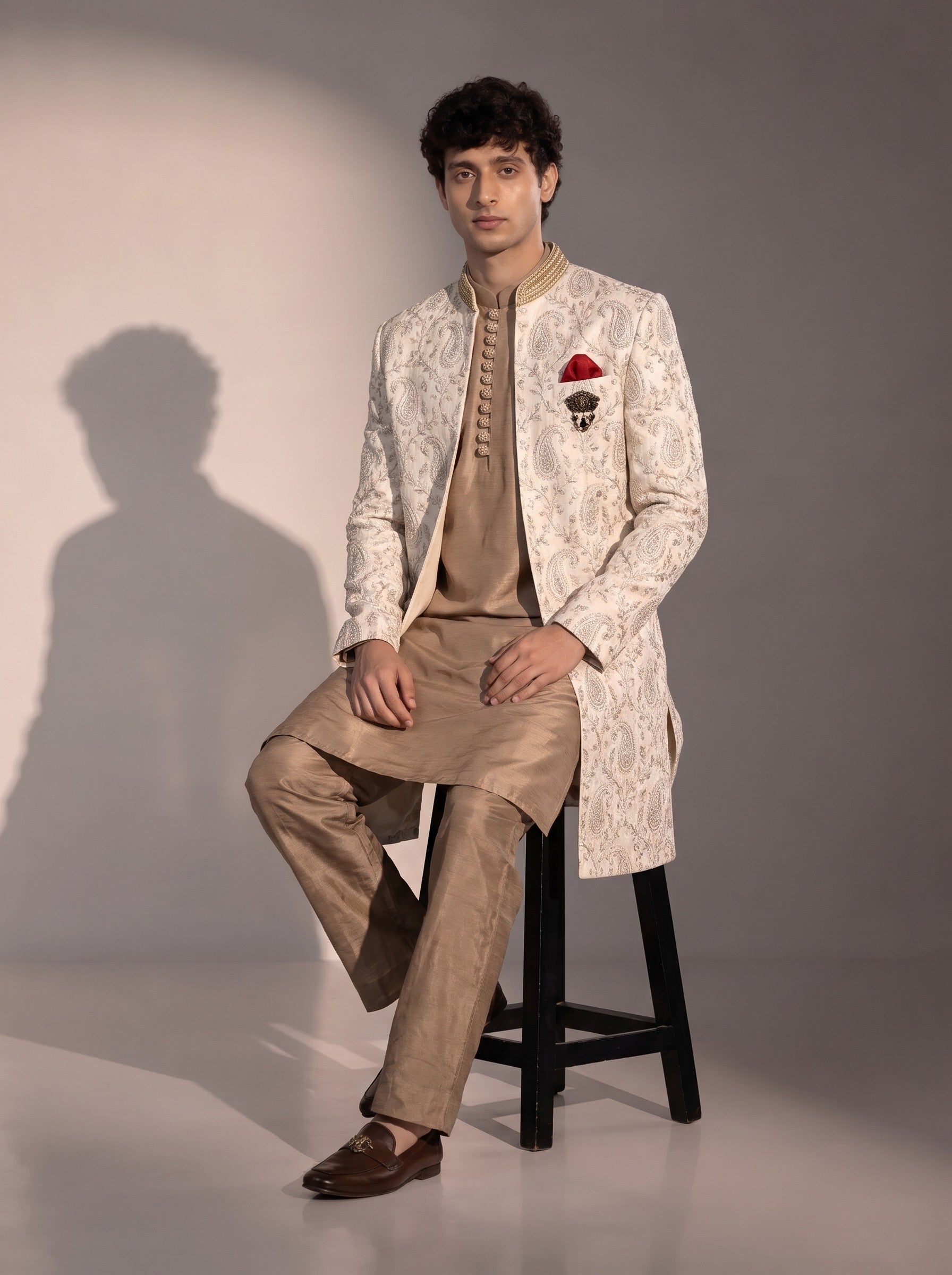 Ivory paisley embroidered silk indowestern for men - seated pose