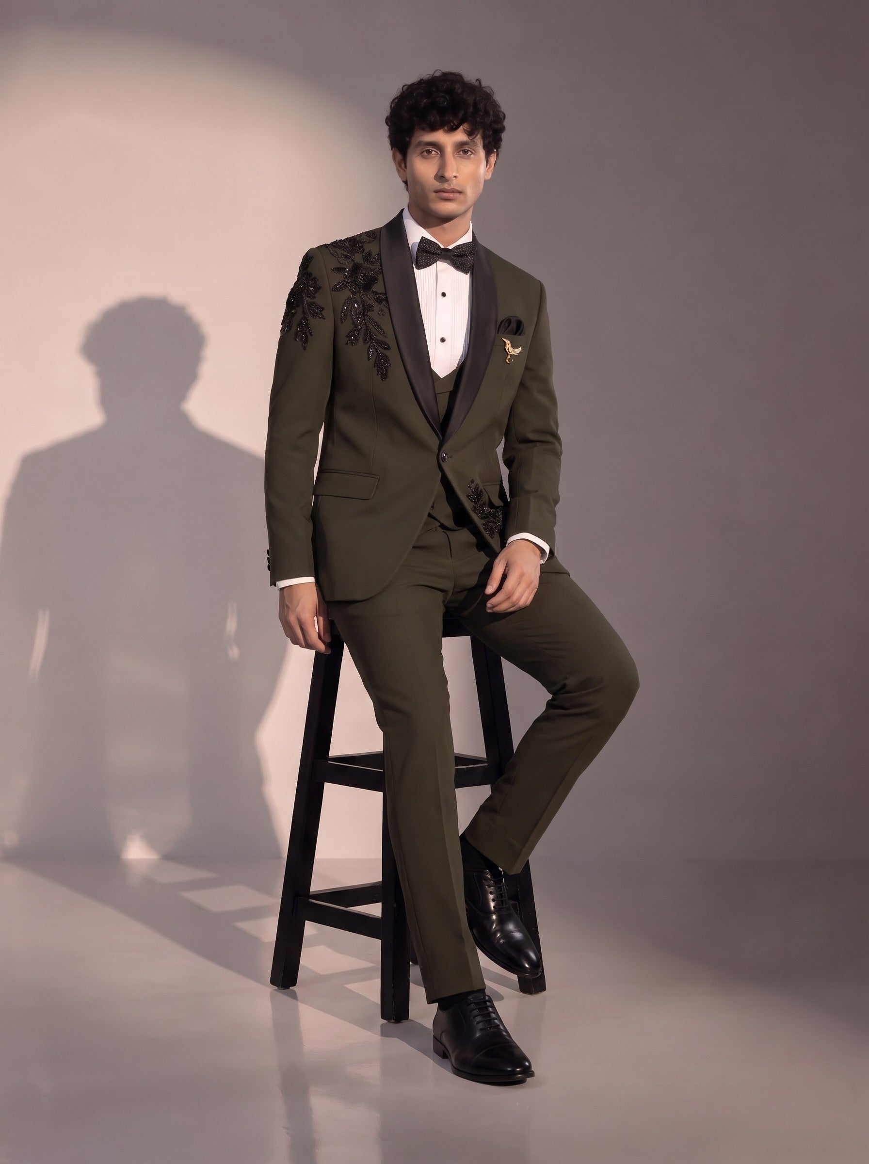 Olive floral embellished tuxedo suit for men - seated pose
