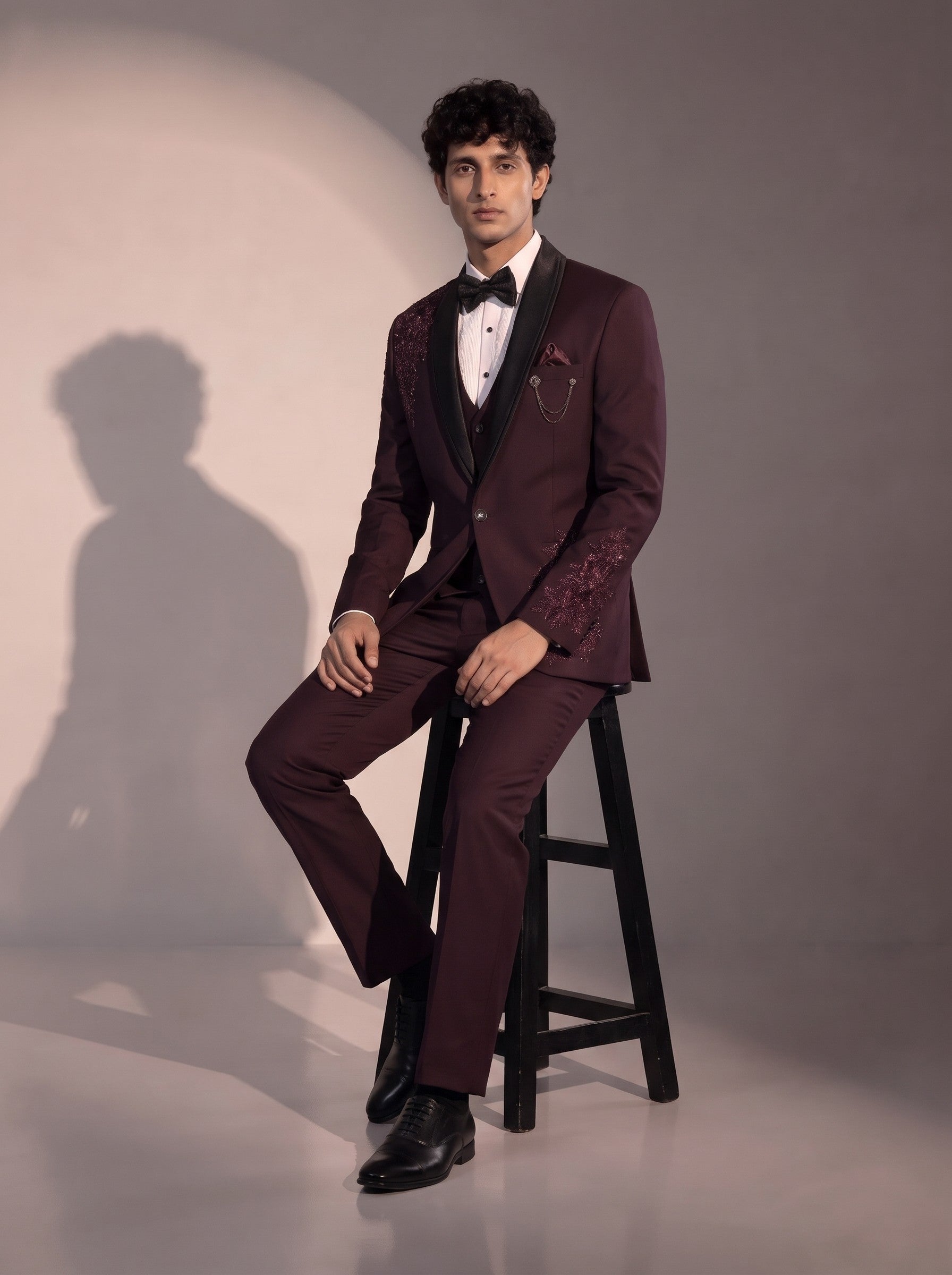 Wine floral embellished tuxedo suit for men - seated pose